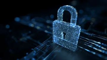 A laptop glowing with a bright login prompt in a minimalistic setup, symbolizing the protected access system at XXBB.